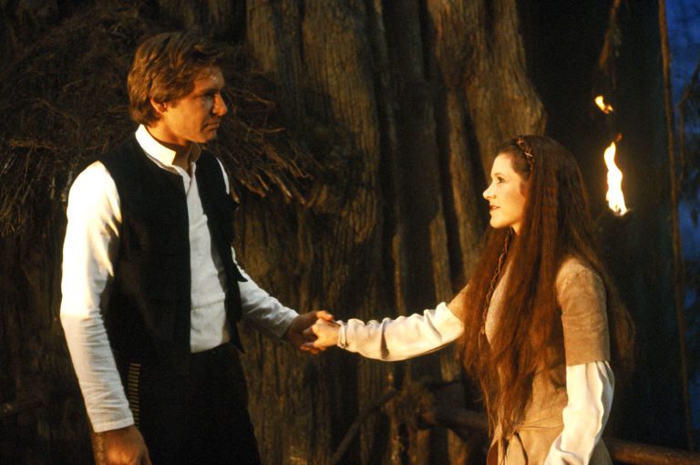 1482877480-syn-elm-1482864444-hbz-carrie-fisher-1983-harrison-ford-shutterstock-editorial-5886269ds-large