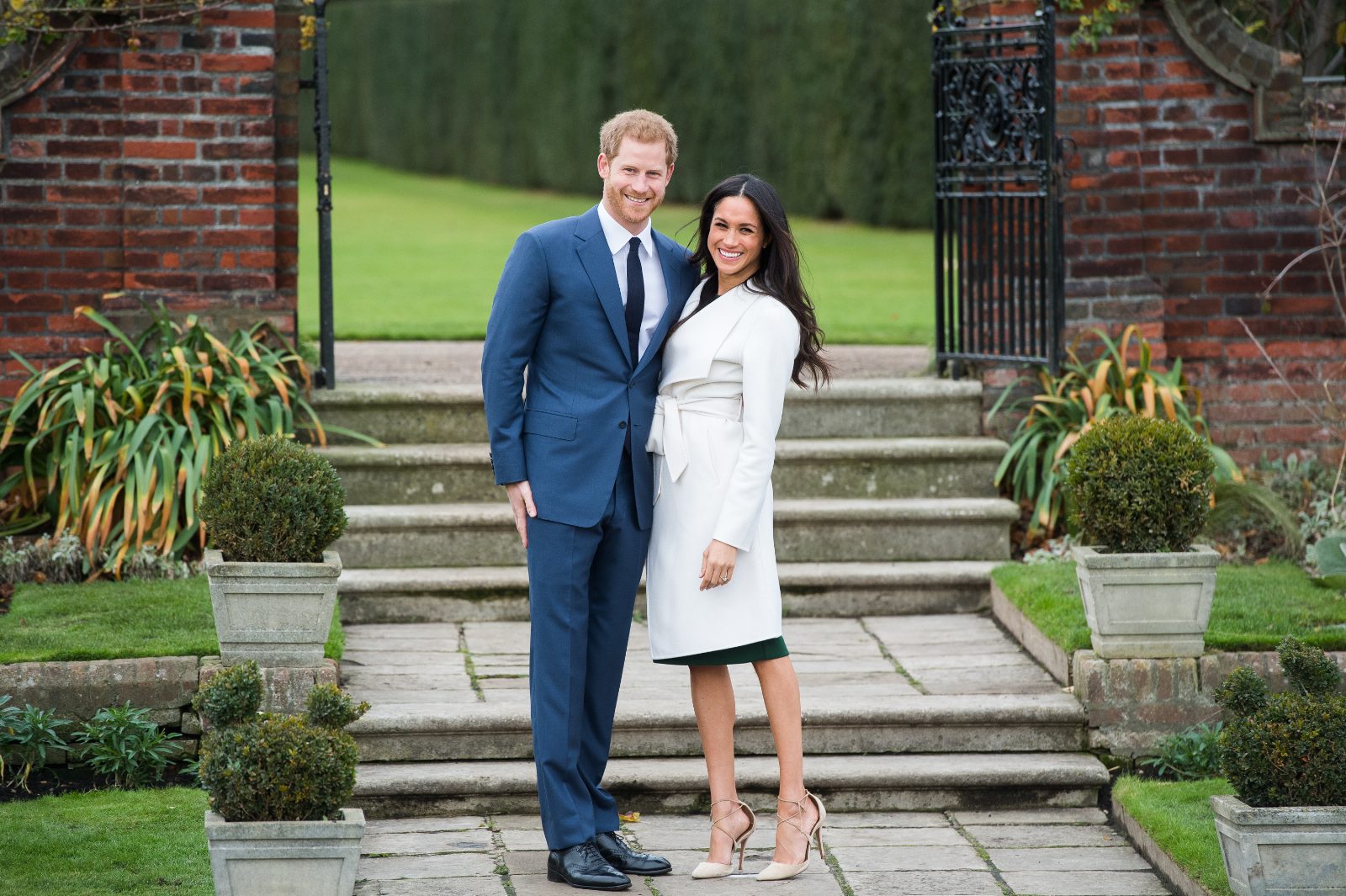 LONDON, ENGLAND - NOVEMBER 27: Prince Harry and Meghan Markle during an official photocall to announce the engagement of Prince Harry and actress Meghan Markle at The Sunken Gardens at Kensington Palace on November 27, 2017 in London, England. Prince Harry and Meghan Markle have been a couple officially since November 2016 and are due to marry in Spring 2018. (Photo by Samir Hussein/Samir Hussein/WireImage)